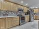Close up view of a kitchen featuring stainless steel appliances and tile backsplash at 6494 N Baltimore Rd, Monrovia, IN 46157