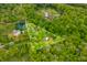 Aerial view of a two acre wooded lot of land with a pond and house and out buildings at 680 Unity Church Rd, Morgantown, IN 46160