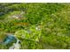 Overhead view of 2 acres in Morgantown, Indiana, with a pond and surrounded by lush green trees at 680 Unity Church Rd, Morgantown, IN 46160