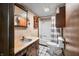 Cozy bathroom with patterned wallpaper, vanity and a tub with shower at 680 Unity Church Rd, Morgantown, IN 46160