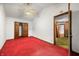 Bedroom with red carpet, white walls, and closet with bi-fold doors at 680 Unity Church Rd, Morgantown, IN 46160