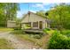 Exterior of a home featuring a red metal roof, a detached garage, and a grassy lawn at 680 Unity Church Rd, Morgantown, IN 46160