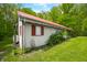 Exterior view of a white sided house with red shutters, roof and manicured lawn at 680 Unity Church Rd, Morgantown, IN 46160