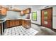Traditional kitchen featuring wood cabinetry, white countertops and a black and white tiled floor at 680 Unity Church Rd, Morgantown, IN 46160