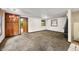 Living room with retro light fixture, neutral carpet, vintage wood cabinets, and wood burning fireplace at 680 Unity Church Rd, Morgantown, IN 46160