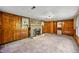 A classic living room featuring wood paneled walls and a charming brick fireplace at 680 Unity Church Rd, Morgantown, IN 46160