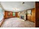 Cozy living room featuring a brick fireplace and wood-paneled walls at 680 Unity Church Rd, Morgantown, IN 46160