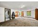 Open-concept living space featuring a retro wood burning fireplace, vintage wood cabinets, and a view of bathroom at 680 Unity Church Rd, Morgantown, IN 46160