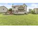 Spacious backyard with a wooden deck, screened-in porch, and lush green lawn perfect for outdoor activities at 6818 Bluffridge Dr, Indianapolis, IN 46278