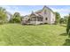 Expansive backyard featuring a screened-in porch and lush green lawn, perfect for outdoor activities at 6818 Bluffridge Dr, Indianapolis, IN 46278