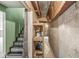 Unfinished basement with open ceiling, concrete foundation, and shelving for storage at 6818 Bluffridge Dr, Indianapolis, IN 46278