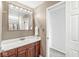 View of bathroom with wood cabinets, sink, and medicine cabinet with Hollywood style lighting at 6818 Bluffridge Dr, Indianapolis, IN 46278