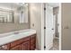View of bathroom with wood cabinets, sink, and medicine cabinet with Hollywood style lighting at 6818 Bluffridge Dr, Indianapolis, IN 46278