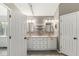 Bathroom vanity offers dual sinks, decorative mirrors, and updated lighting at 6818 Bluffridge Dr, Indianapolis, IN 46278
