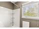 Bright bathroom view of shower/tub and window with view to the outside at 6818 Bluffridge Dr, Indianapolis, IN 46278