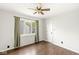 Bedroom with white walls, wood floors, and large window with view to the outside at 6818 Bluffridge Dr, Indianapolis, IN 46278