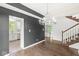 Elegant dining area with hardwood floors, modern lighting, and open access to the kitchen at 6818 Bluffridge Dr, Indianapolis, IN 46278