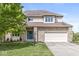 Charming two-story home with brick accents, attached garage, and well-manicured lawn at 6818 Bluffridge Dr, Indianapolis, IN 46278