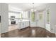 Well-lit kitchen featuring white cabinets, stainless steel appliances, and an adjacent dining area at 6818 Bluffridge Dr, Indianapolis, IN 46278