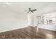 Living room with hardwood floors, ceiling fan, and open floor plan at 6818 Bluffridge Dr, Indianapolis, IN 46278
