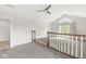 A spacious living room with a ceiling fan and natural light from large arched window at 6818 Bluffridge Dr, Indianapolis, IN 46278