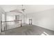 Open living room features vaulted ceiling with fan, and a view of the lower level at 6818 Bluffridge Dr, Indianapolis, IN 46278