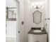 Powder room with vanity, mirror, and decorative lighting at 6818 Bluffridge Dr, Indianapolis, IN 46278