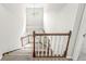Staircase with wood railing and carpeted steps leading to the upper level at 6818 Bluffridge Dr, Indianapolis, IN 46278