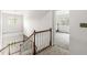 Staircase with wood railing and carpeted steps leading to the upper level at 6818 Bluffridge Dr, Indianapolis, IN 46278