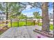 Wooden back deck with railing, offering a view of the expansive backyard at 695 W Clinton St, Danville, IN 46122
