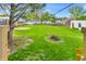 Spacious backyard featuring a fire pit, shed, and ample green space at 695 W Clinton St, Danville, IN 46122