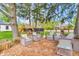 Relaxing outdoor seating area with wicker chairs and a custom-built wooden deck surrounded by trees at 695 W Clinton St, Danville, IN 46122