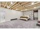 Finished basement bedroom with patterned accent wall, neutral paint, and carpeted floor at 695 W Clinton St, Danville, IN 46122