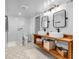 Updated bathroom with dual sinks, modern lighting, and hexagon tile floors at 695 W Clinton St, Danville, IN 46122