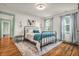 Bedroom with wood floors, large rug, and green trim and door at 695 W Clinton St, Danville, IN 46122