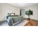 Bedroom features a bed with green comforter, hardwood floors, and attached television at 695 W Clinton St, Danville, IN 46122