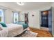 Bright bedroom features hardwood floors, a walk-in closet, and access to the home's front entryway at 695 W Clinton St, Danville, IN 46122