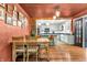 Cozy dining room with hardwood floors, exposed brick, and stylish light fixtures overlooking the kitchen at 695 W Clinton St, Danville, IN 46122