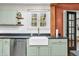 Kitchen featuring stainless steel dishwasher and farmhouse sink with gold faucet at 695 W Clinton St, Danville, IN 46122