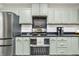 The kitchen offers stainless steel appliances, light green cabinets, and dark countertops at 695 W Clinton St, Danville, IN 46122