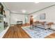 Spacious living room with hardwood floors, a comfortable sofa, and a view into other rooms at 695 W Clinton St, Danville, IN 46122