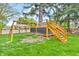 Backyard play structure featuring a swing set and platform with stairs at 695 W Clinton St, Danville, IN 46122