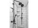 Updated shower with white subway tile, modern matte black fixtures, and built in shelves at 695 W Clinton St, Danville, IN 46122