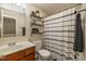 Bathroom showcasing a vanity, toilet, and shower with decorative curtain at 7140 Lakeland Trails Blvd, Indianapolis, IN 46259