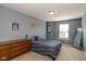 Bedroom with neutral colored walls, comfortable bed and dresser at 7140 Lakeland Trails Blvd, Indianapolis, IN 46259