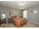 Bedroom featuring neutral walls, side tables, and a window, creating a relaxing ambiance at 7140 Lakeland Trails Blvd, Indianapolis, IN 46259
