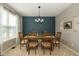 Cozy dining room with stylish chandelier, wood table, and accent wall at 7140 Lakeland Trails Blvd, Indianapolis, IN 46259