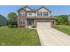 Charming two-story brick home with well-maintained landscaping and a two-car attached garage at 7140 Lakeland Trails Blvd, Indianapolis, IN 46259