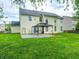 Large, grassy backyard with a covered patio, ideal for outdoor activities at 725 Bristle Lake Dr, Brownsburg, IN 46112