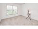 Bright bedroom featuring neutral carpet, a large window with blinds, and ample natural light at 725 Bristle Lake Dr, Brownsburg, IN 46112